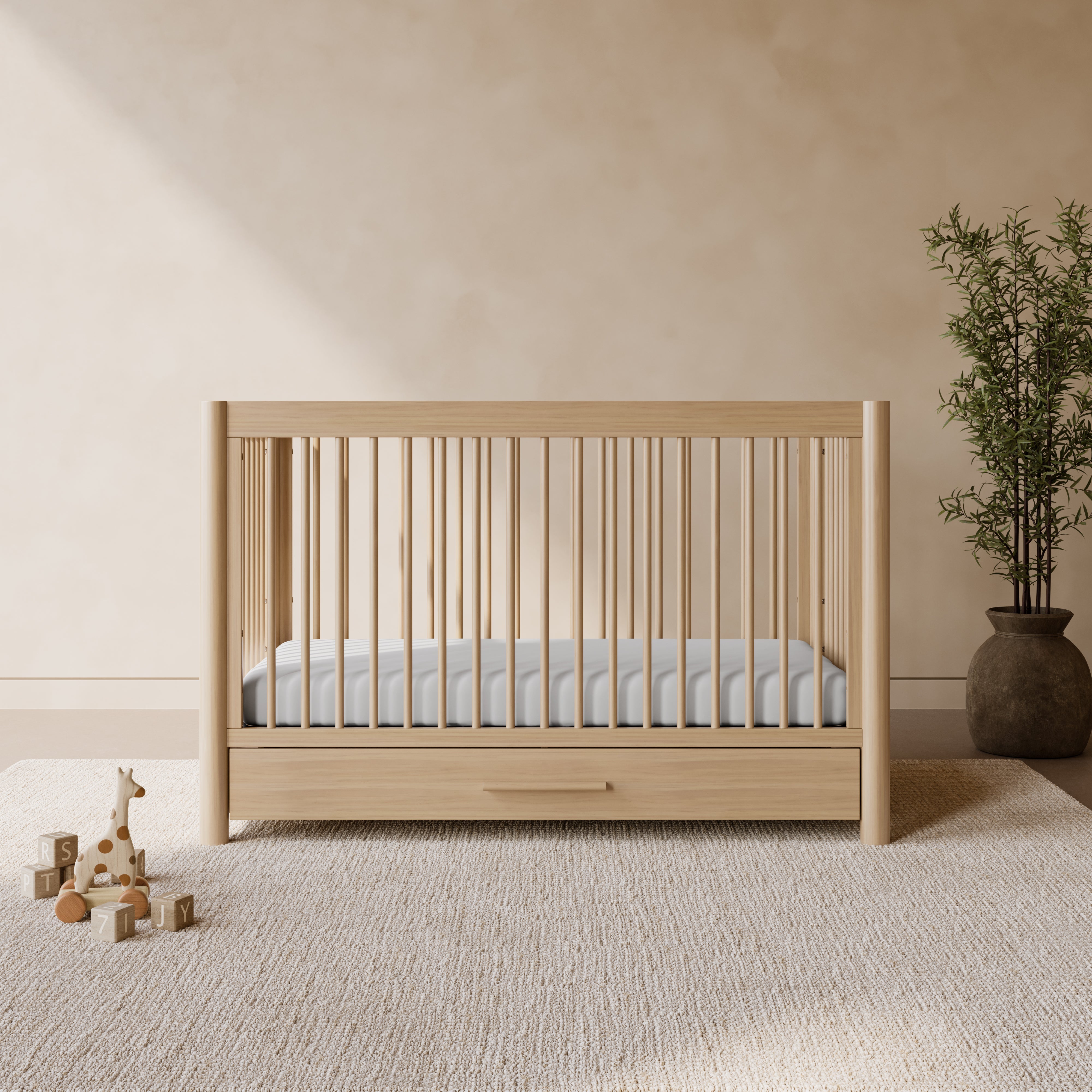 Malta driftwood crib with drawer in a nursery