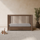 Malta hazelnut crib with drawer in a nursery