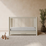 Malta frosted oat crib with drawer in a nursery