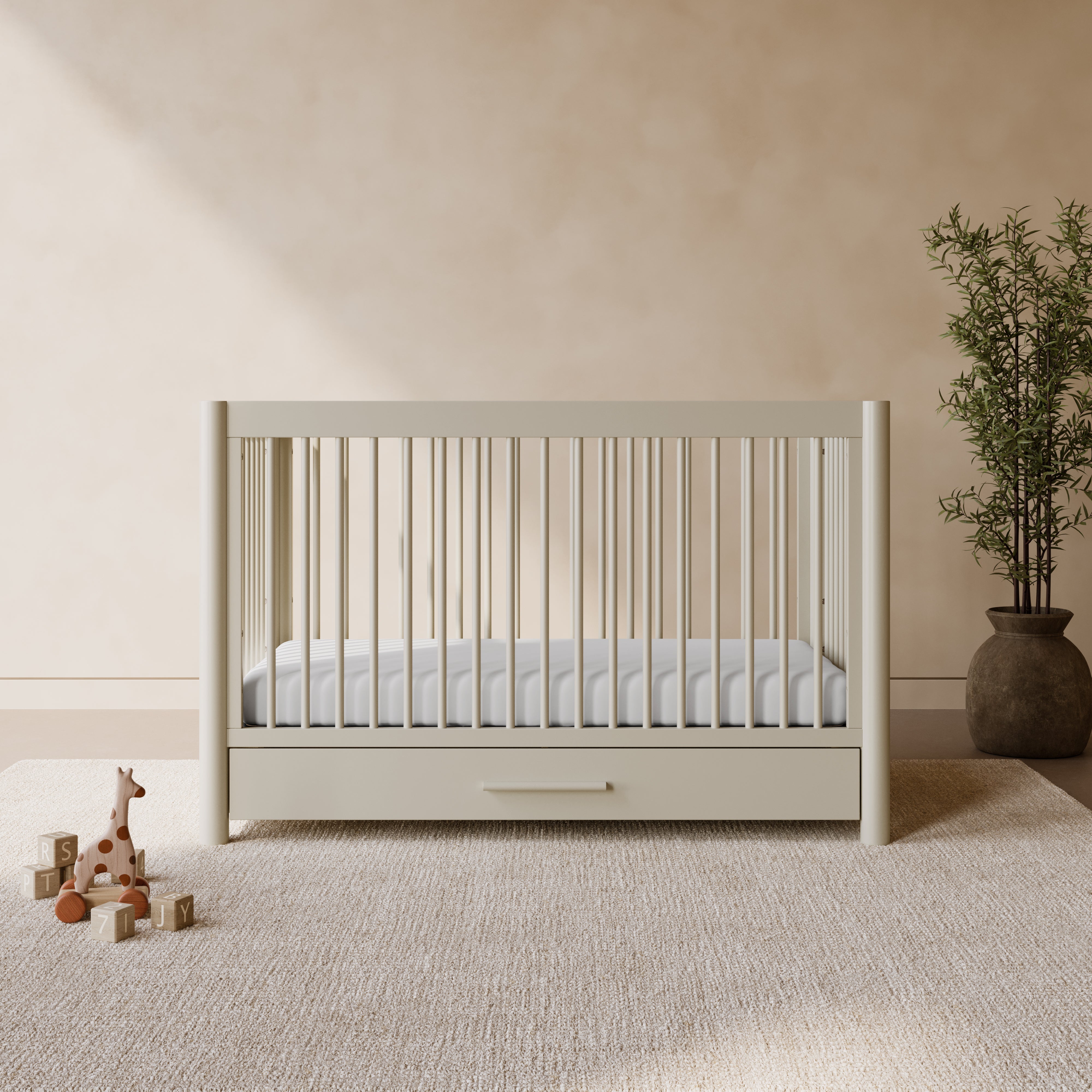 Malta frosted oat crib with drawer in a nursery