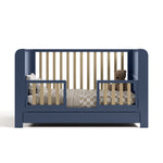 Read-with-me midnight blue with driftwood crib converted to toddler bed with two guardrails