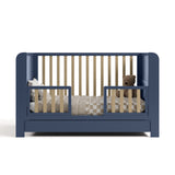 Read-with-me midnight blue with driftwood crib converted to toddler bed with two guardrails