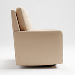 Swivel glider with latte fabric in a room