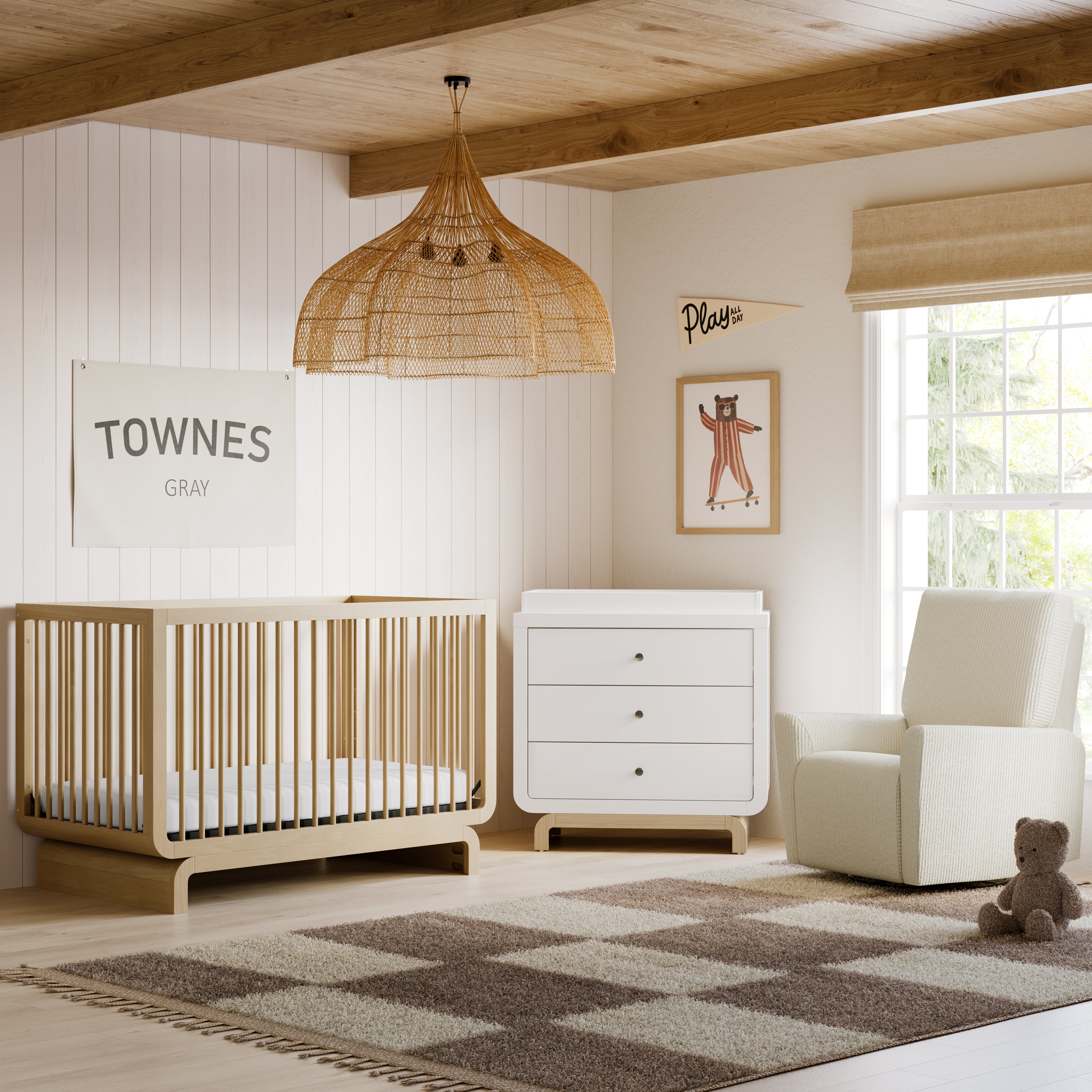Storkcraft santorini driftwood crib in nursery next to glider and chest