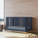 Santos midnight blue with natural crib in a nursery
