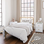 2 Santos white 2 drawer nightstands in kids bedroom with bed in middle